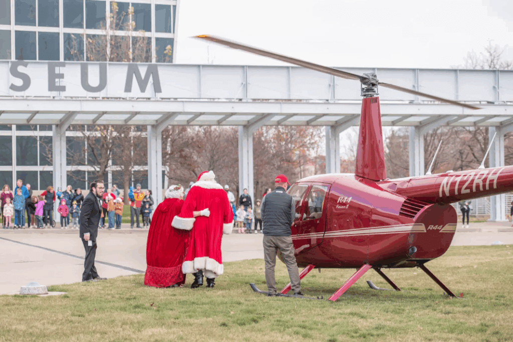 santa and mrs.claus exiting from a helicopter