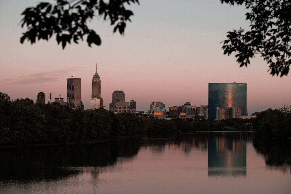 Indy skyline in the background, with the White River in the foreground, at dusk
