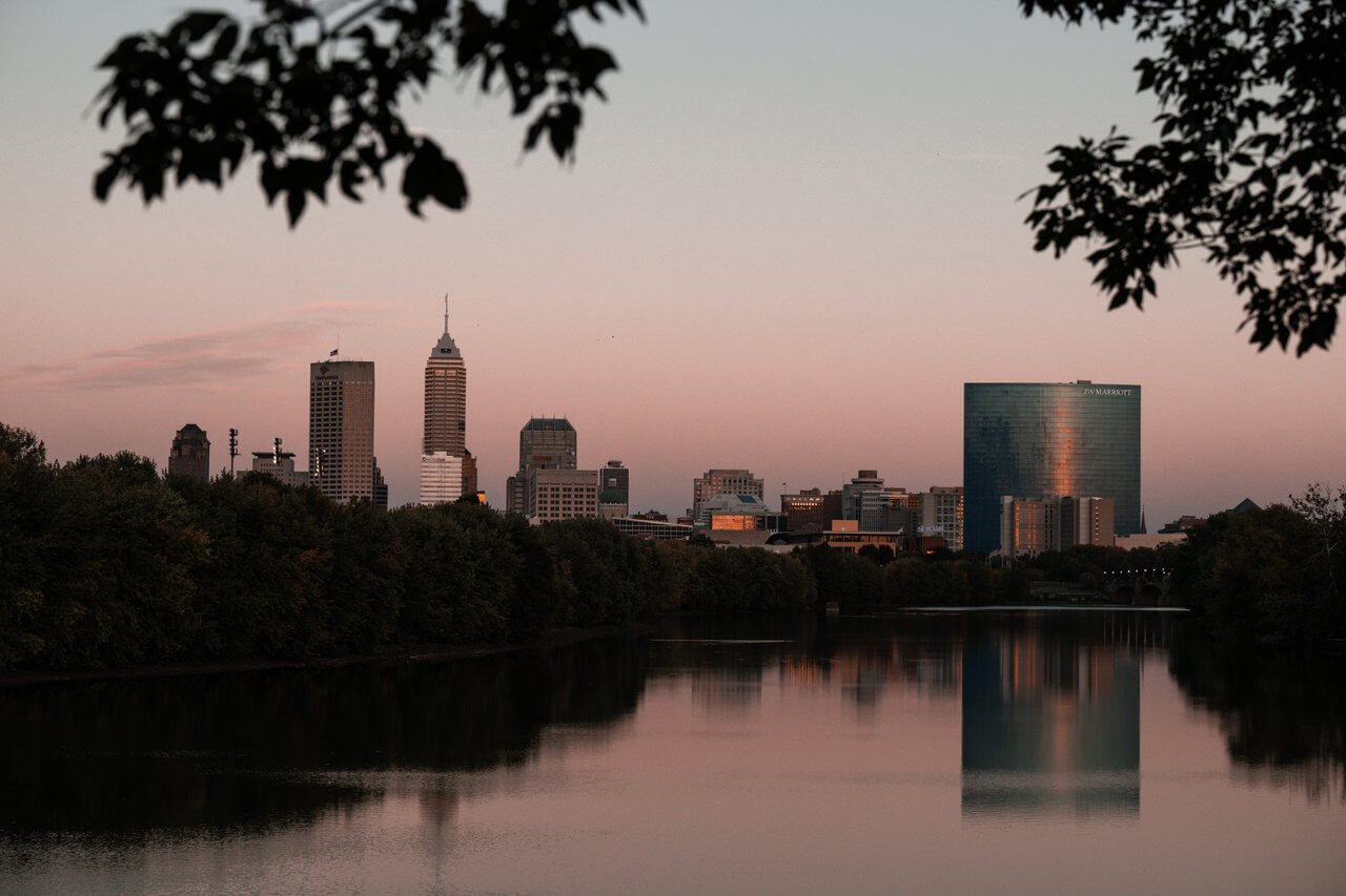Indy skyline in the background, with the White River in the foreground, at dusk