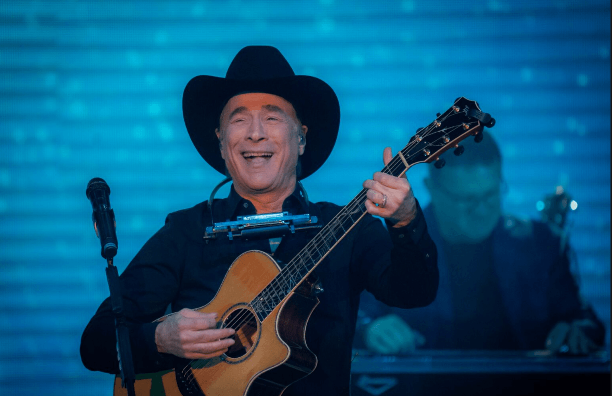 Clint Black performing with guitar