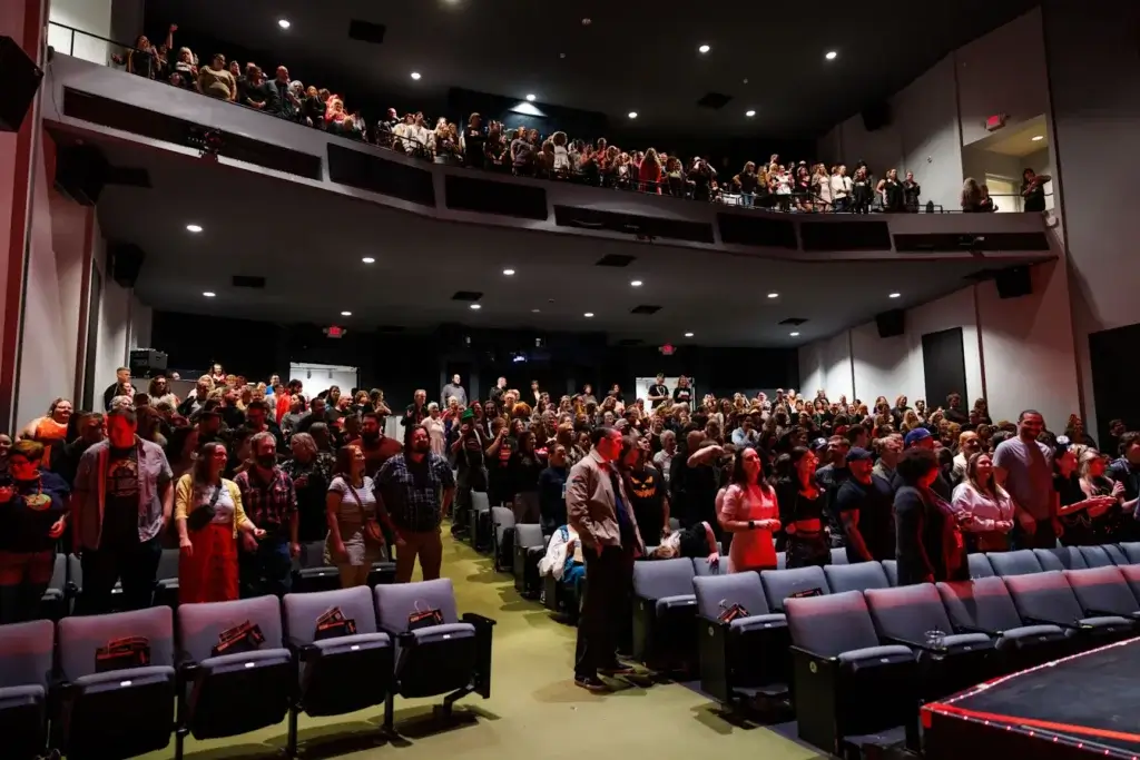 Filled seats of people attending newfields theater