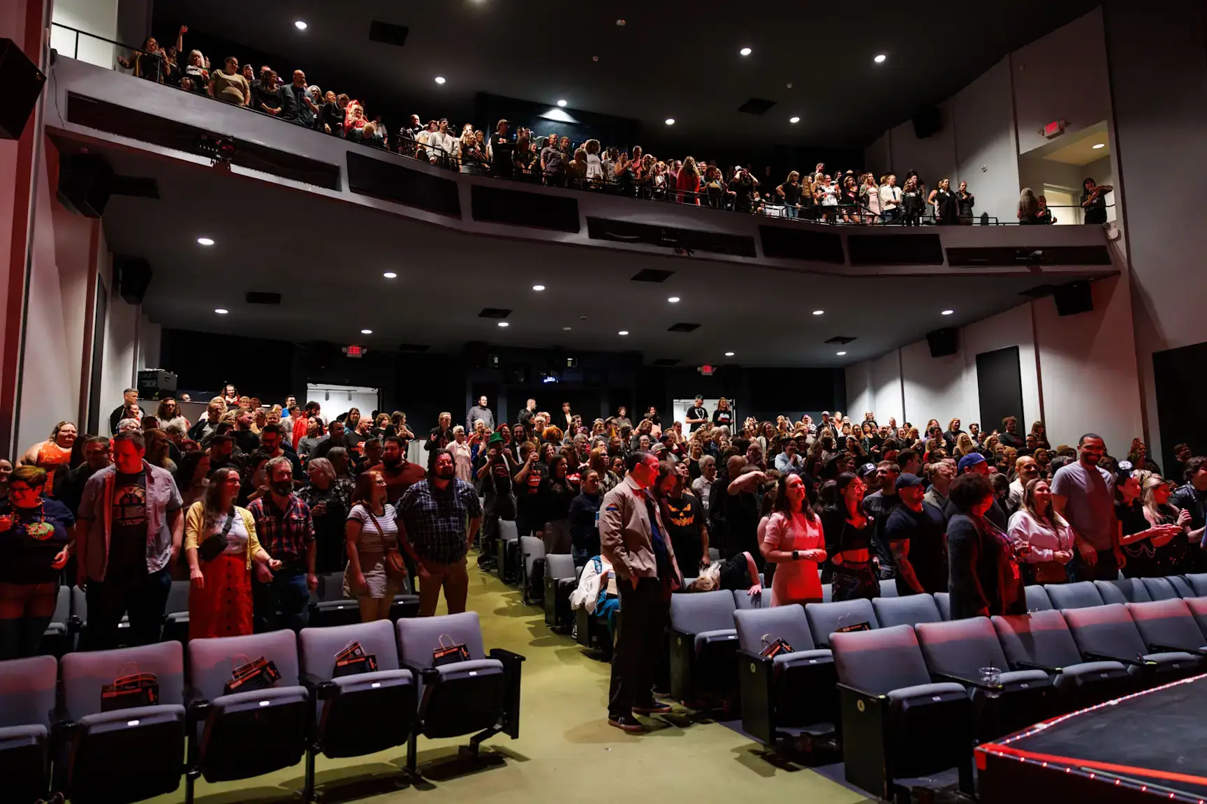 Filled seats of people attending newfields theater